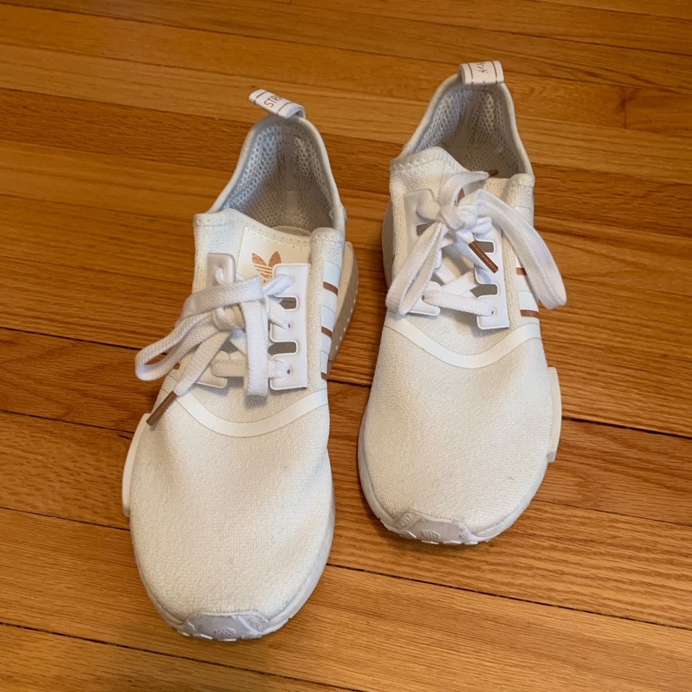 White and gold women’s Adidas NMD sneakers